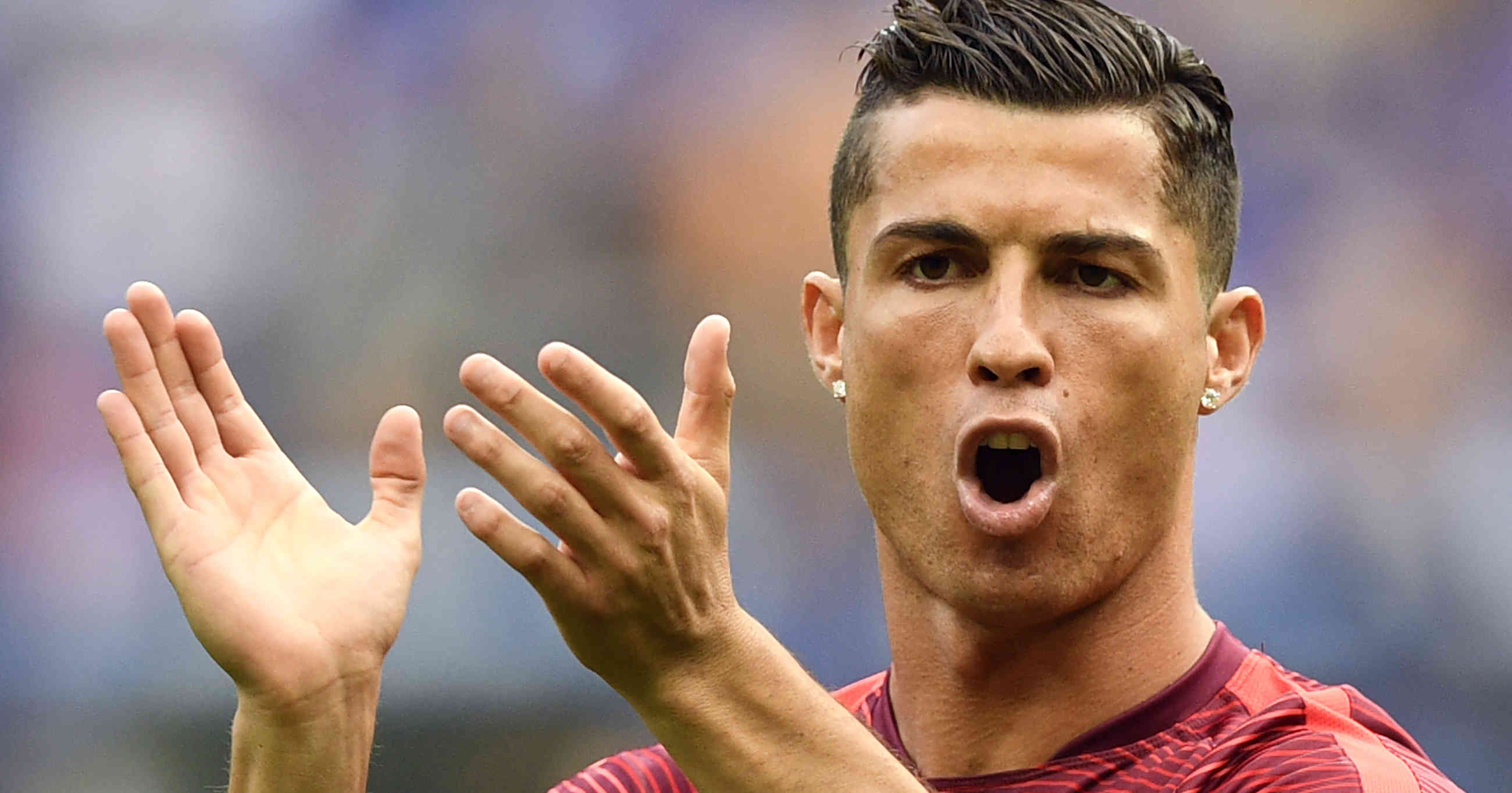 (FILES) This file photo taken on July 10, 2016 shows Portugal's forward Cristiano Ronaldo claping as he walks on the pitch prior to the start of the Euro 2016 final football match between France and Portugal at the Stade de France in Saint-Denis, north of Paris. Cristiano Ronaldo won his fourth Ballon d'Or on December 12, 2016. / AFP PHOTO / MARTIN BUREAU